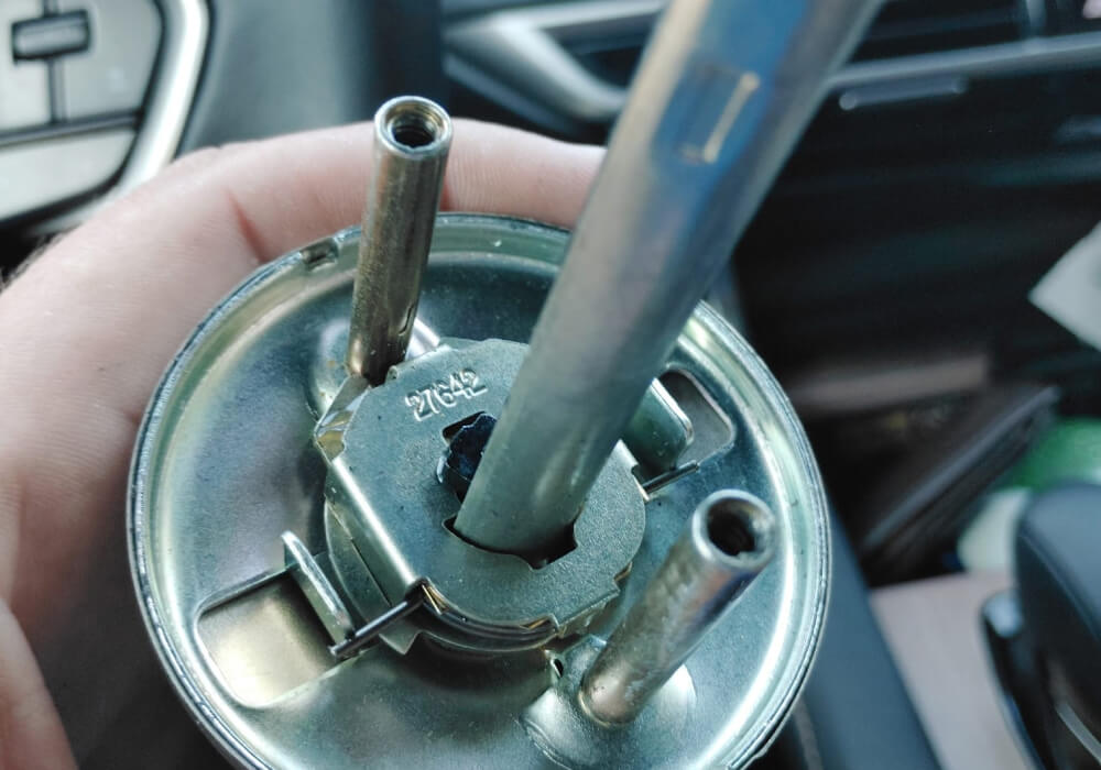 Car ignition lock cylinder removed and held during an ignition repair