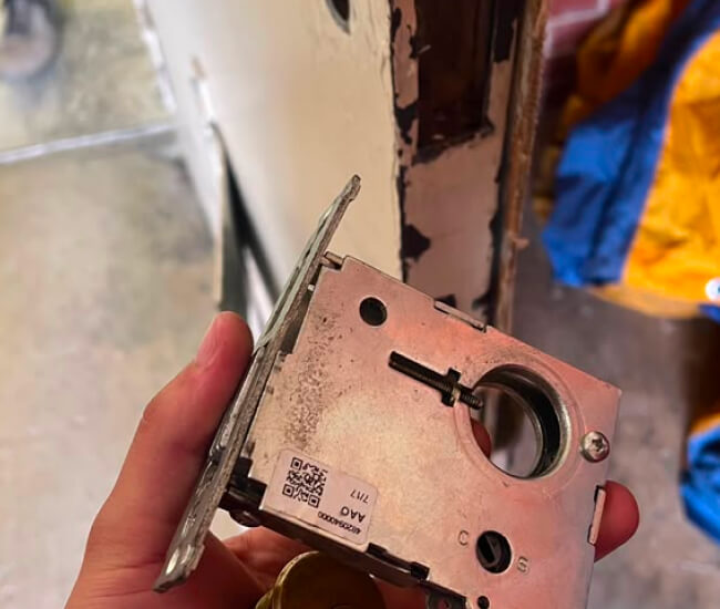 Emergency locksmith removing a damaged mortise lock in Waco