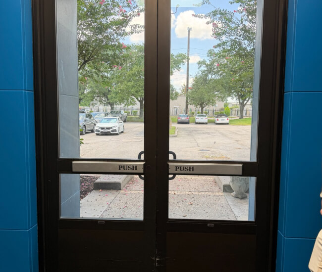 Glass storefront doors with push-bar exit hardware in Temple