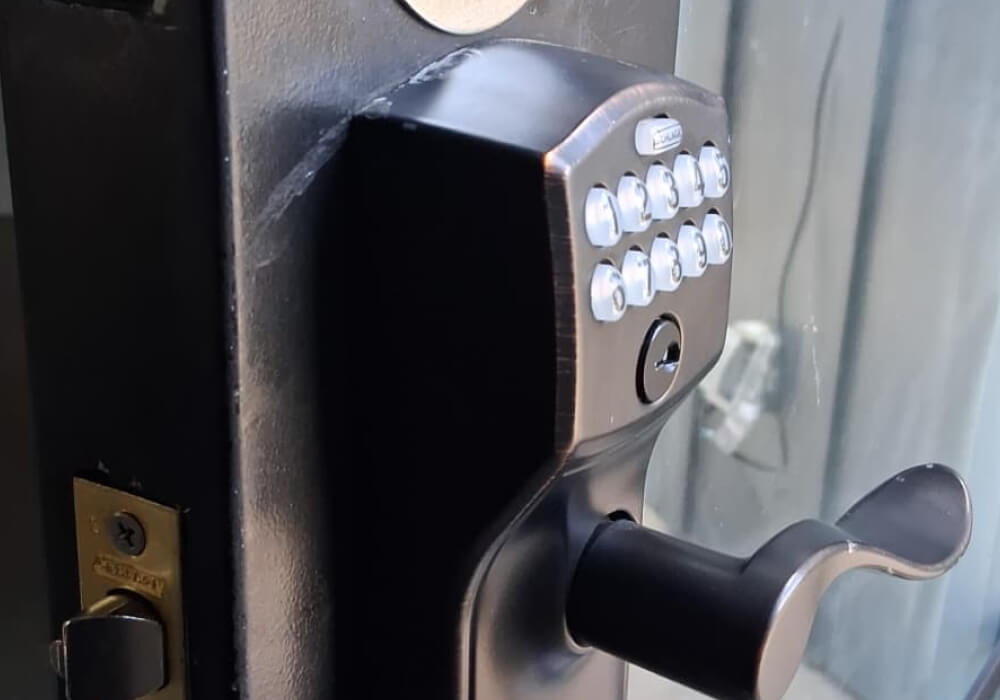 Keypad door lock with lever handle on a commercial glass door