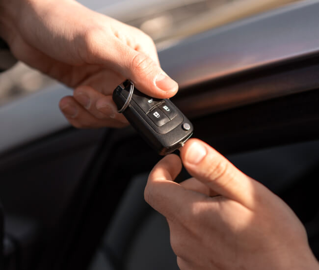 Locksmith handing over a replacement car key in Fort Worth