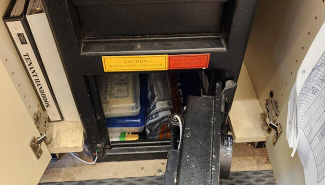 Locksmith opening a commercial drop safe at a Dallas business