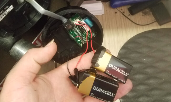 Locksmith opening an electronic safe using external nine volt batteries