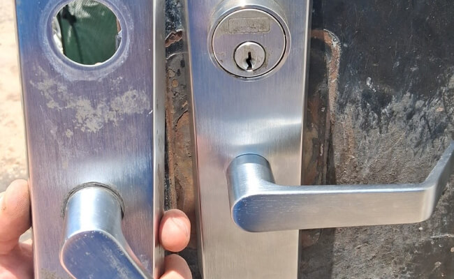 Mobile locksmith in Killeen holding new lever door handles